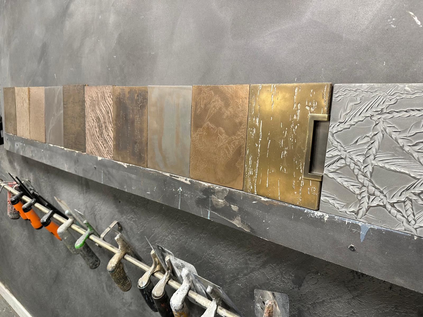 Hand-made Venetian plaster sample boards in multiple designs and colourways on the workshop wall
